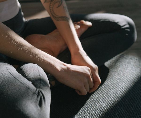 Close-up of a person's hands in a meditative pose.